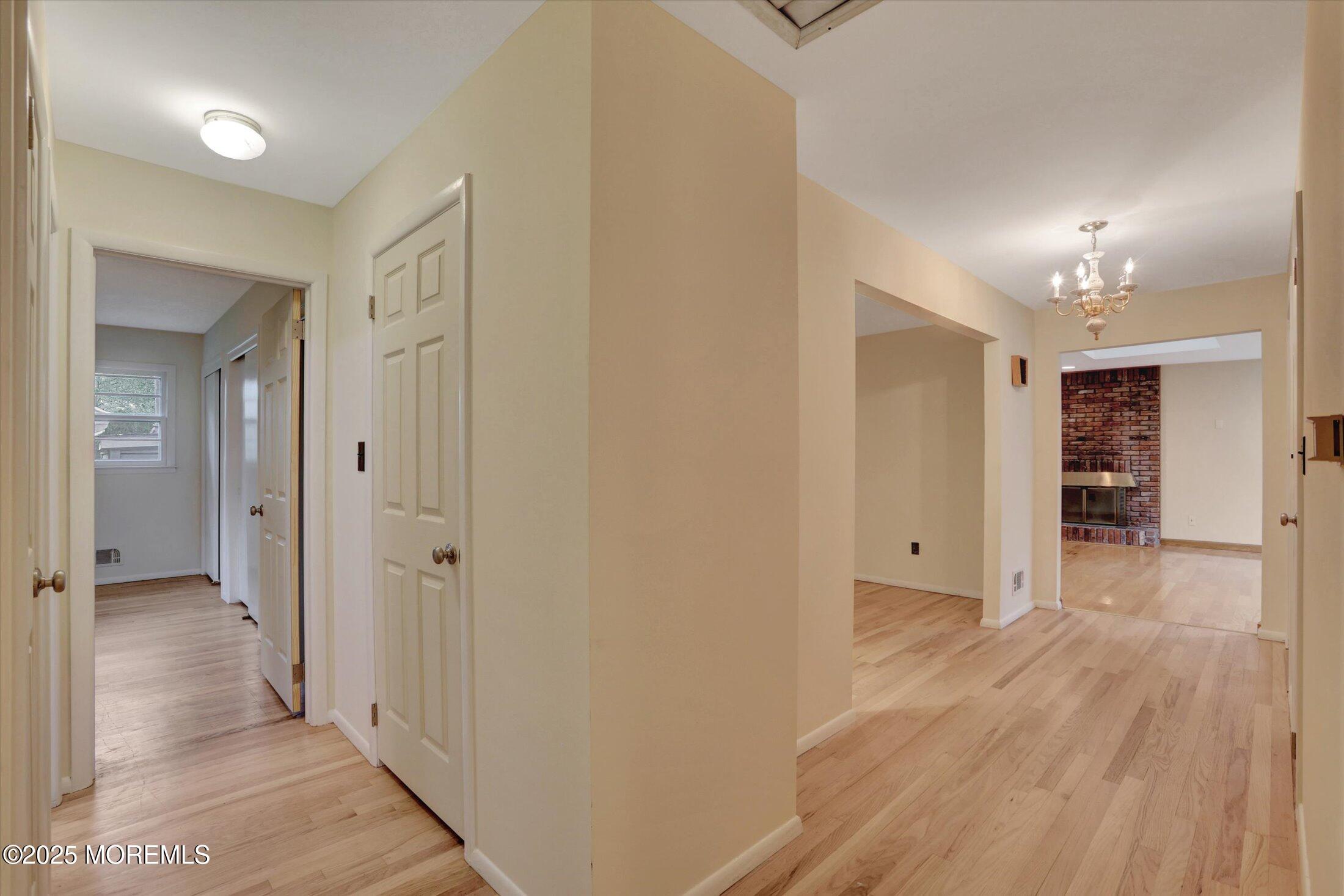 159 Koster Drive Freehold, NJ 07728 - Photo 22 of 37 a view of a hallway with wooden floor and a bathroom