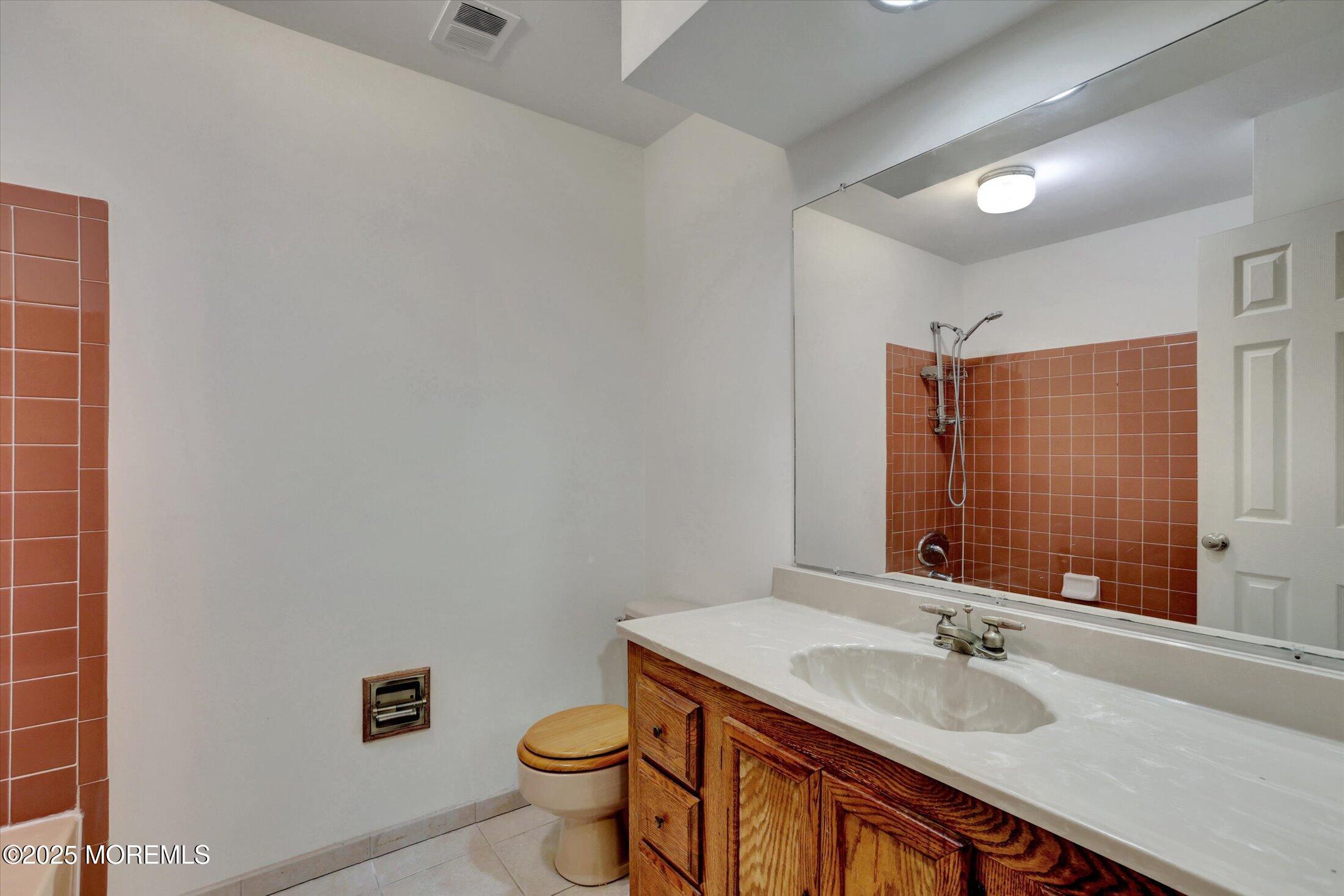 159 Koster Drive Freehold, NJ 07728 - Photo 23 of 37 a bathroom with a granite countertop sink a toilet and a mirror