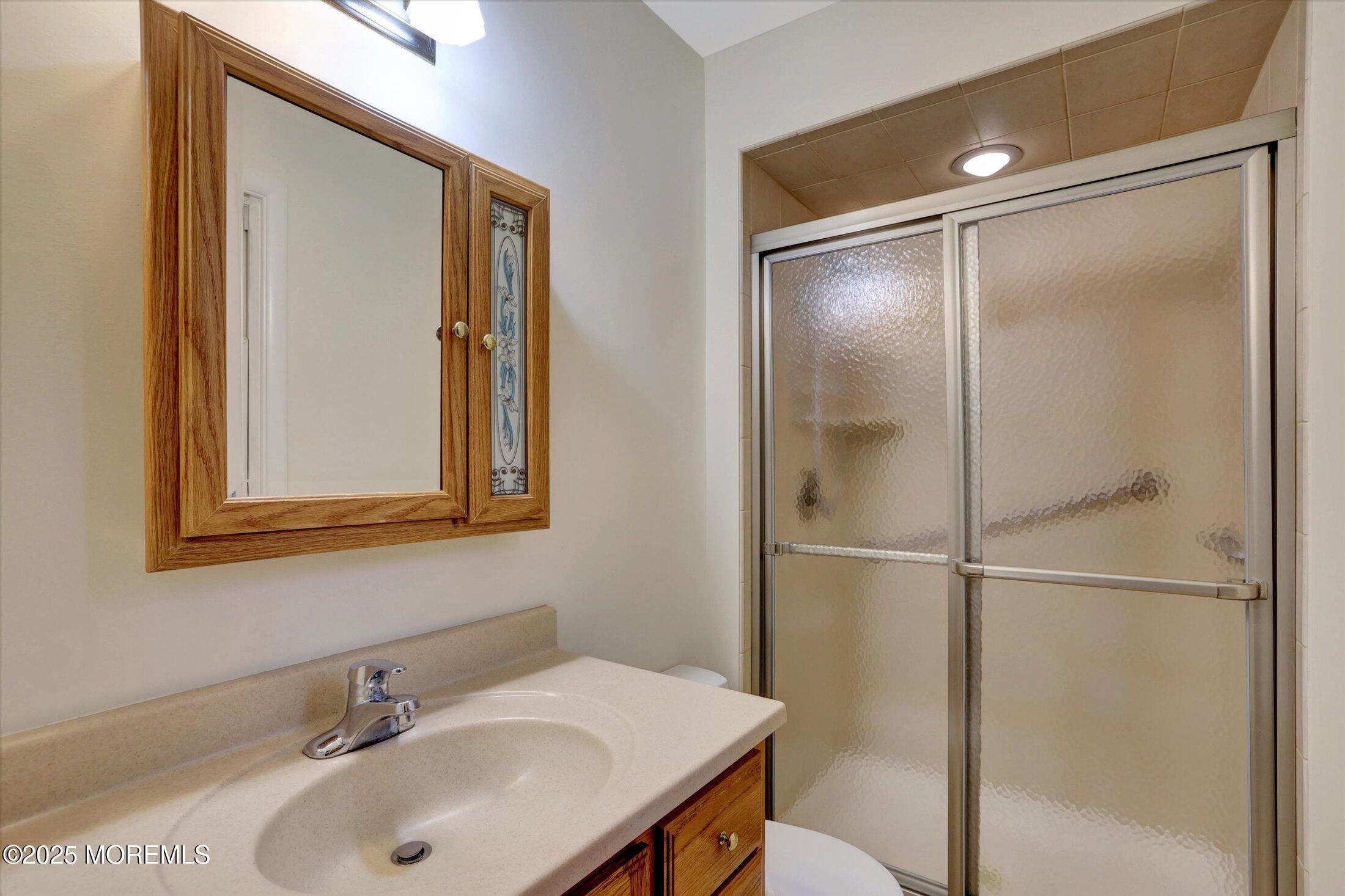 159 Koster Drive Freehold, NJ 07728 - Photo 26 of 37 a bathroom with a sink and mirror