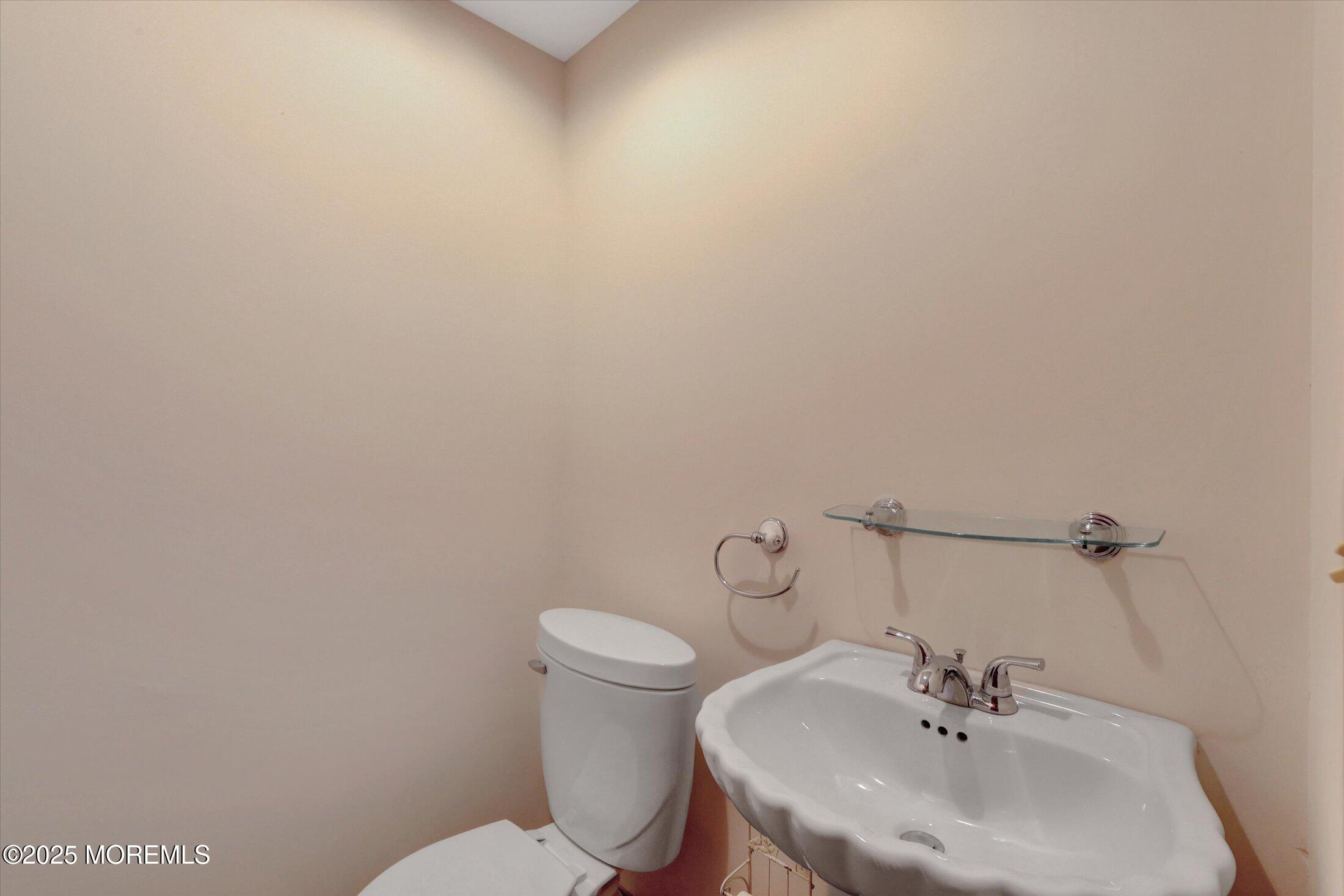 159 Koster Drive Freehold, NJ 07728 - Photo 30 of 37 a bathroom with a sink a toilet and mirror