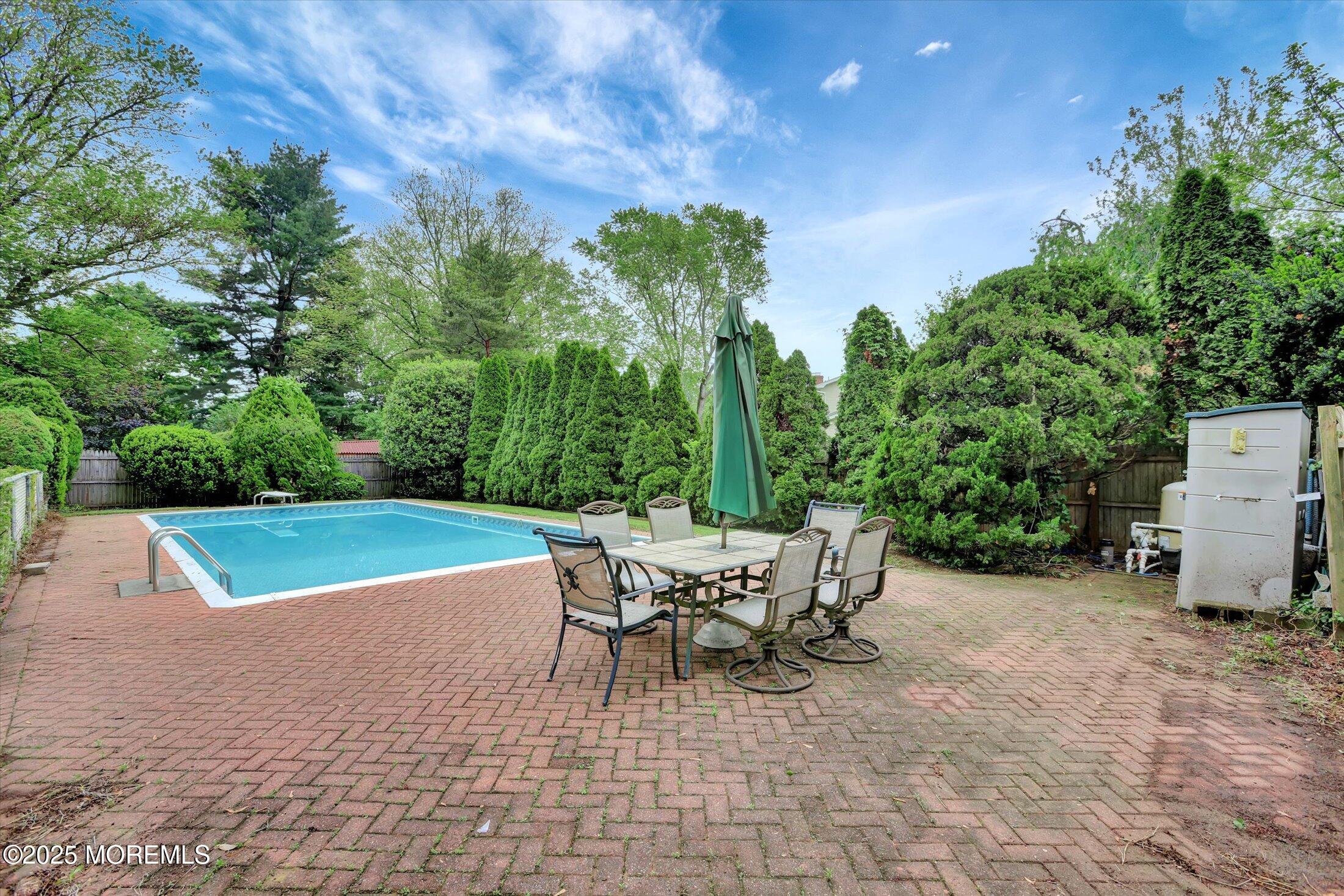 159 Koster Drive Freehold, NJ 07728 - Photo 36 of 37 a patio with a table and chairs and potted plants