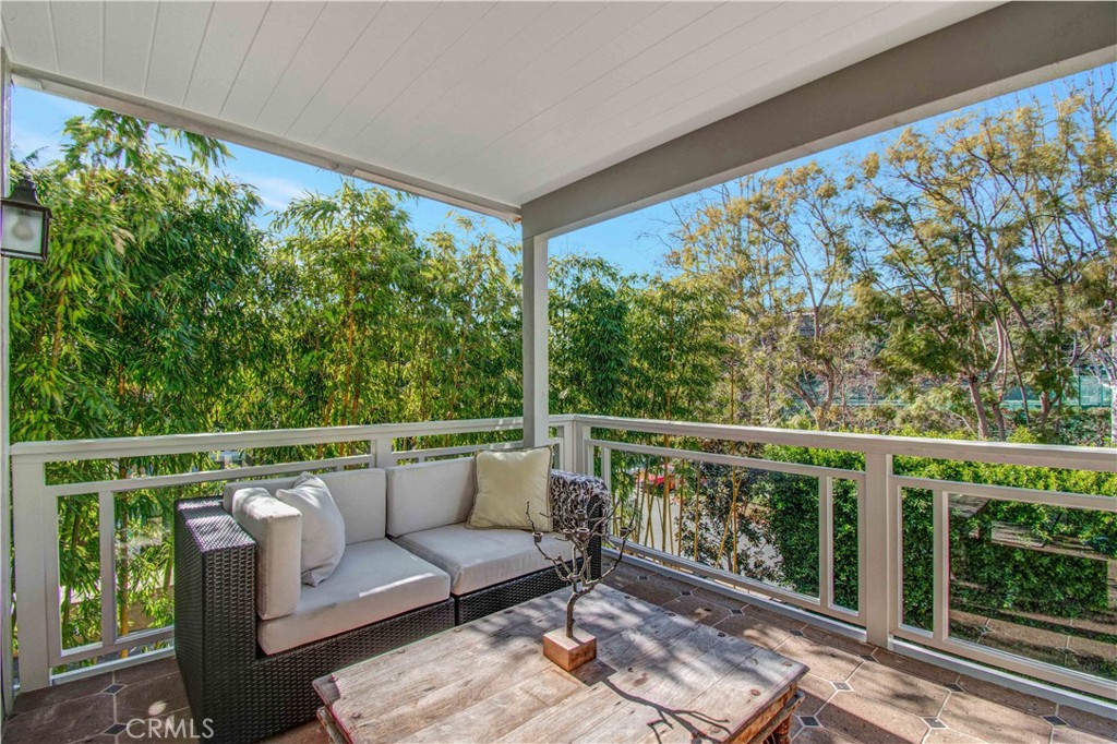 255 Emerald Bay Laguna Beach, CA 92651 - Photo 17 of 27 a balcony with wooden floor and outdoor seating