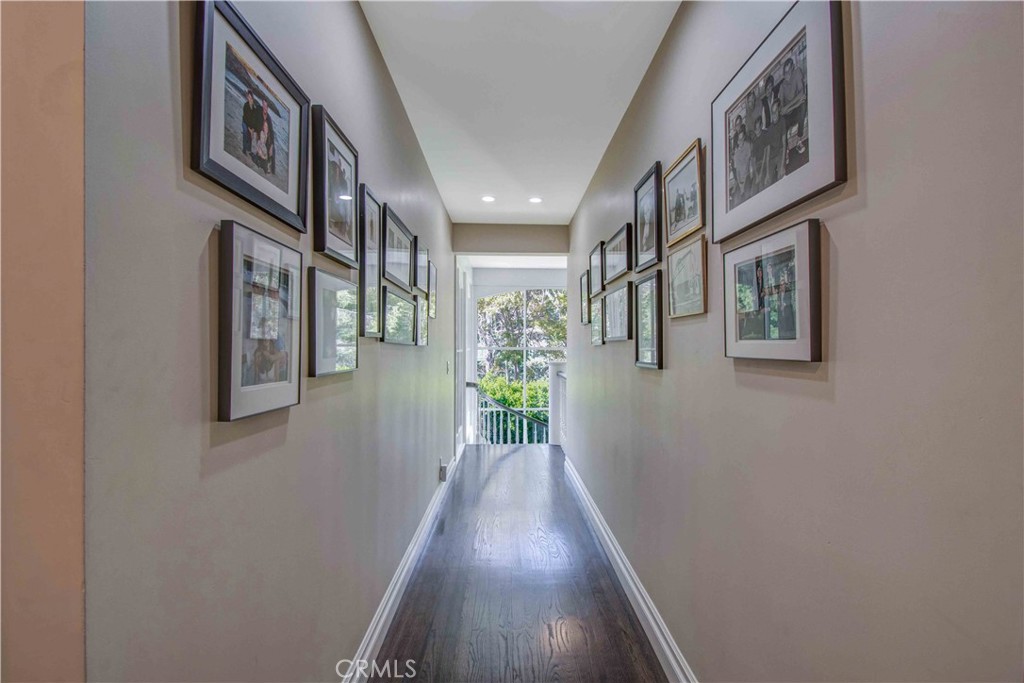 255 Emerald Bay Laguna Beach, CA 92651 - Photo 19 of 27 a view of a hallway with wooden floor and windows