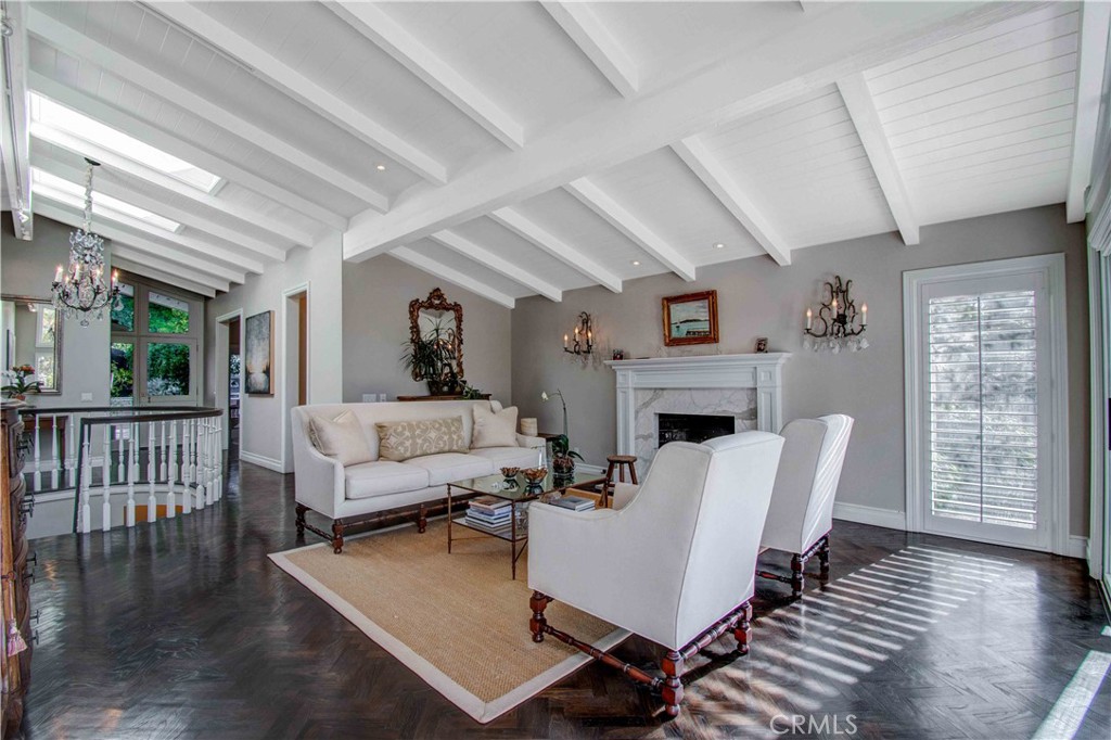 255 Emerald Bay Laguna Beach, CA 92651 - Photo 7 of 27 a living room with furniture a fireplace and a table