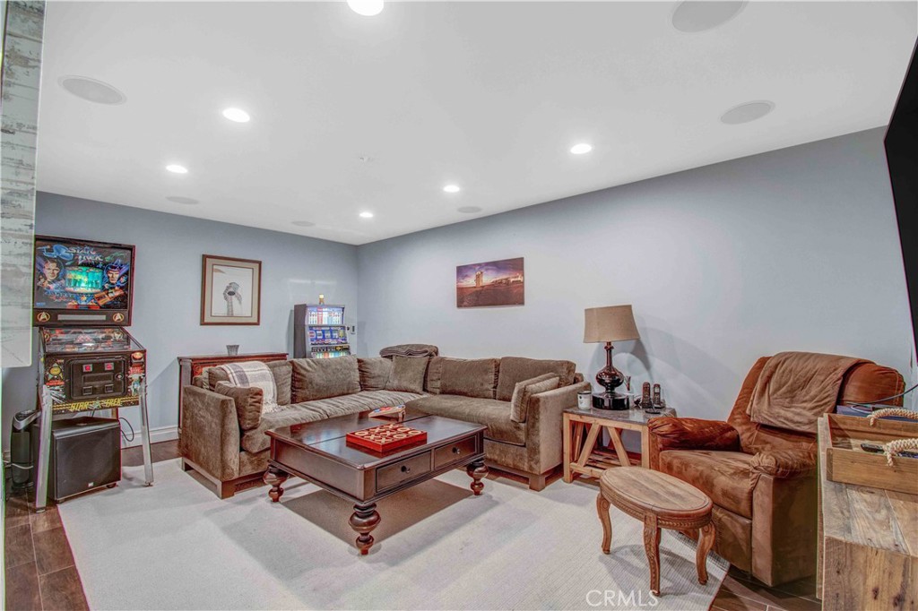 255 Emerald Bay Laguna Beach, CA 92651 - Photo 10 of 27 a living room with furniture a flat screen tv and a bookshelf