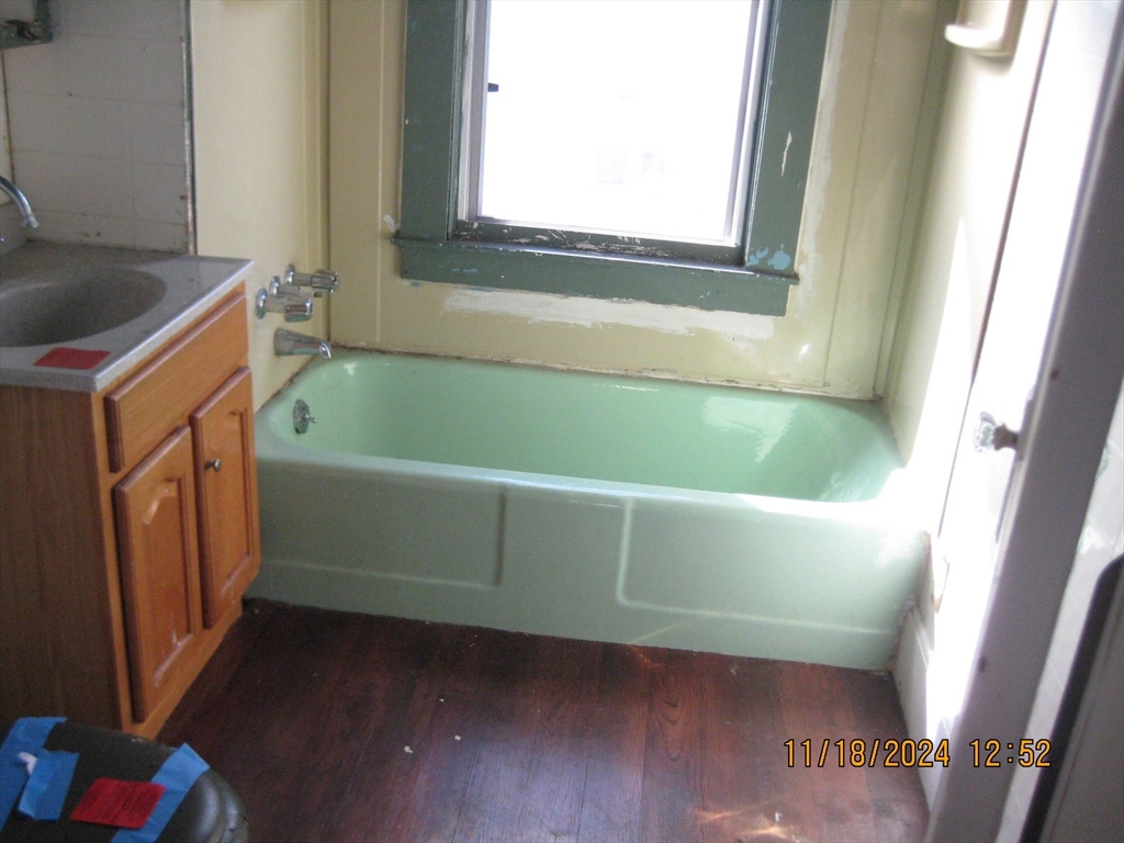 46-48 Wait Street Springfield, MA 01104 - Photo 11 of 19 a bathroom with a tub and a window