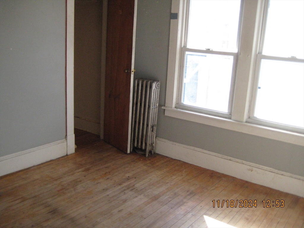 46-48 Wait Street Springfield, MA 01104 - Photo 16 of 19 an empty room with wooden floor and a window