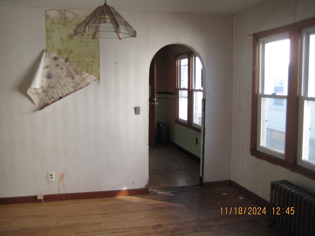 46-48 Wait Street Springfield, MA 01104 - Photo 4 of 19 wooden floor in an empty room with a window
