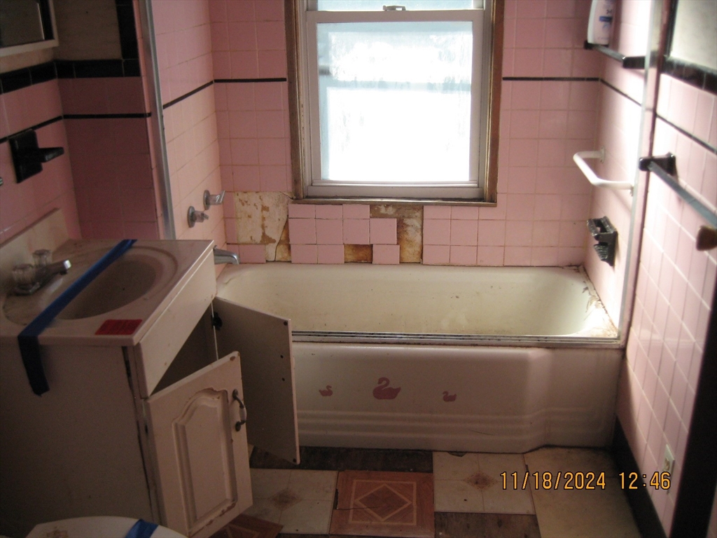 46-48 Wait Street Springfield, MA 01104 - Photo 6 of 19 a bathroom with a bathtub sink and window