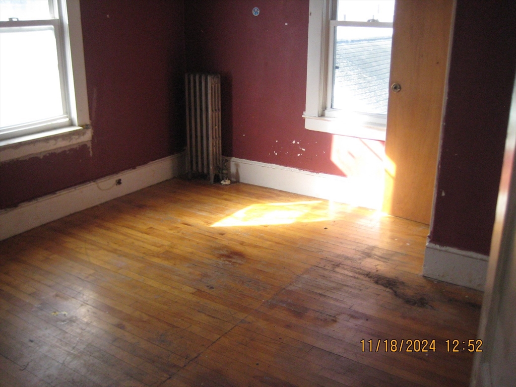 46-48 Wait Street Springfield, MA 01104 - Photo 10 of 19 an empty room with wooden floor and windows
