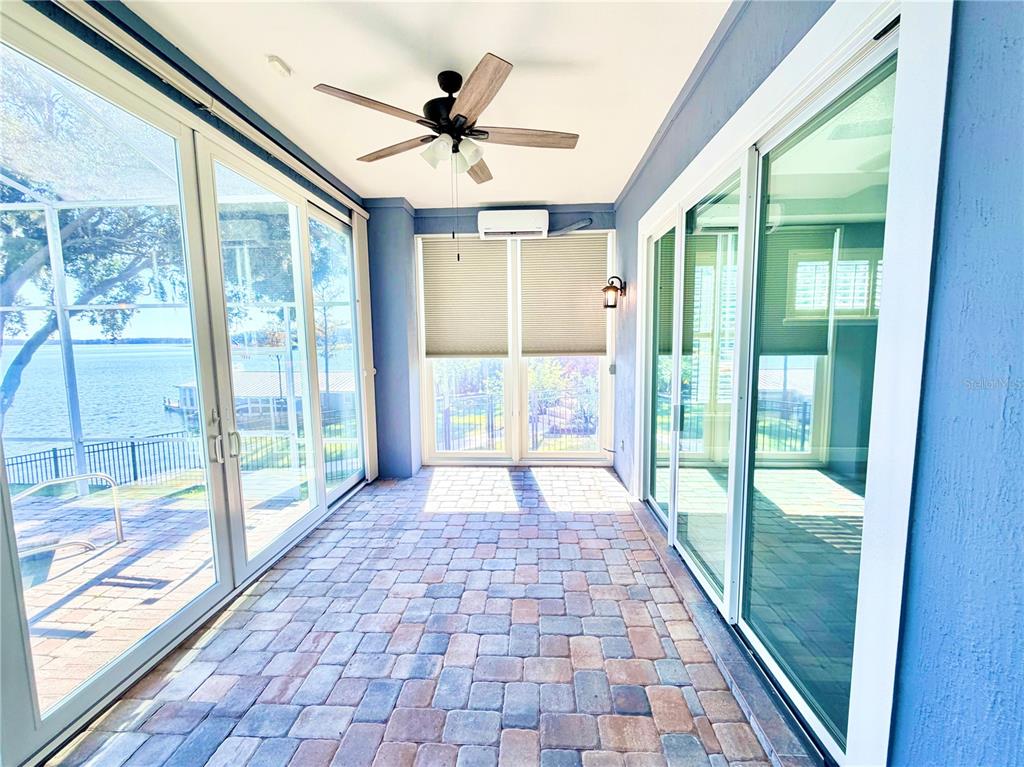 5243 West Lake Butler Road Windermere, FL 34786 - Photo 13 of 43 a view of empty room with wooden floor and windows