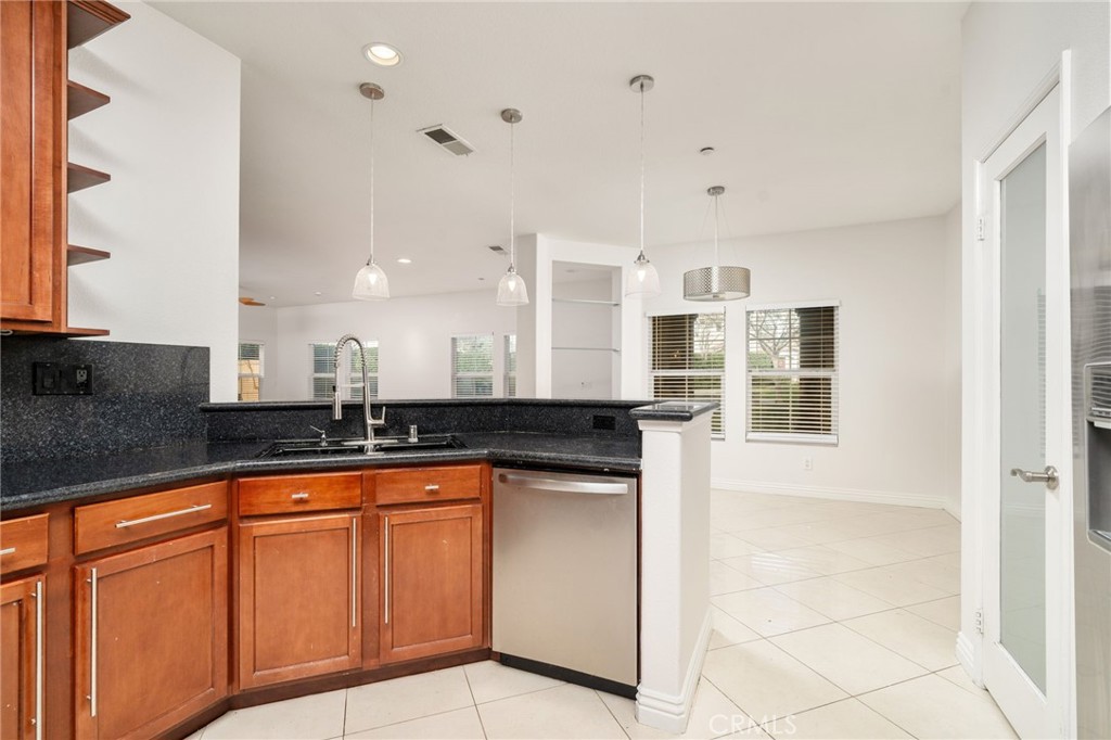 7331 Shelby Place, Unit 102 Rancho Cucamonga, CA 91739 - Photo 15 of 44 a kitchen with granite countertop a sink and cabinets