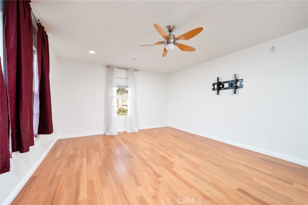 7331 Shelby Place, Unit 102 Rancho Cucamonga, CA 91739 - Photo 25 of 44 a view of a room with wooden floor and white walls