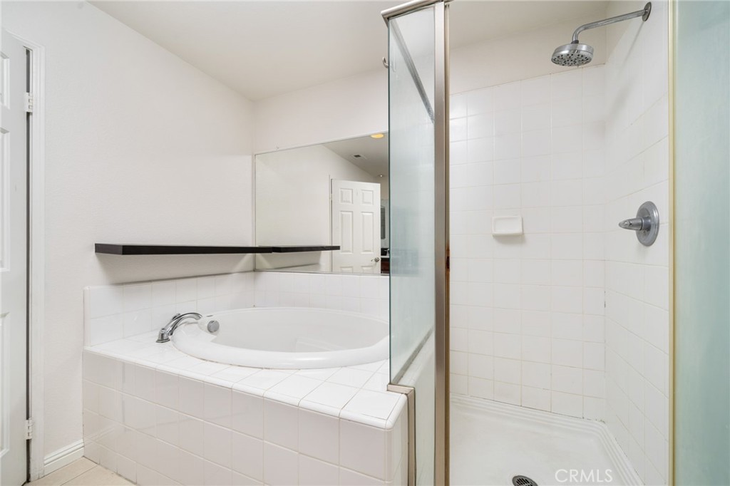 7331 Shelby Place, Unit 102 Rancho Cucamonga, CA 91739 - Photo 27 of 44 a bathroom with a tub and a shower