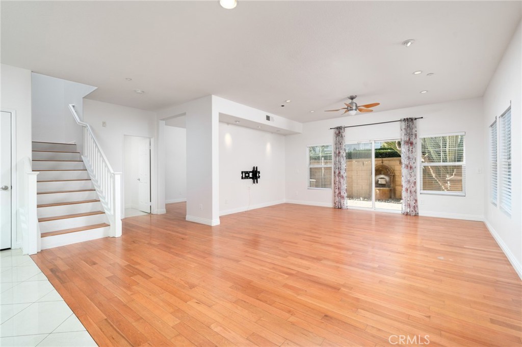 7331 Shelby Place, Unit 102 Rancho Cucamonga, CA 91739 - Photo 5 of 44 a view of an empty room with wooden floor and a window