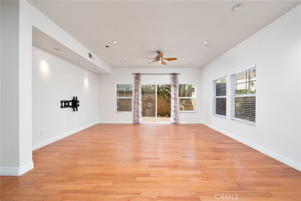 7331 Shelby Place, Unit 102 Rancho Cucamonga, CA 91739 - Photo 6 of 44 a view of an empty room with a window and wooden floor