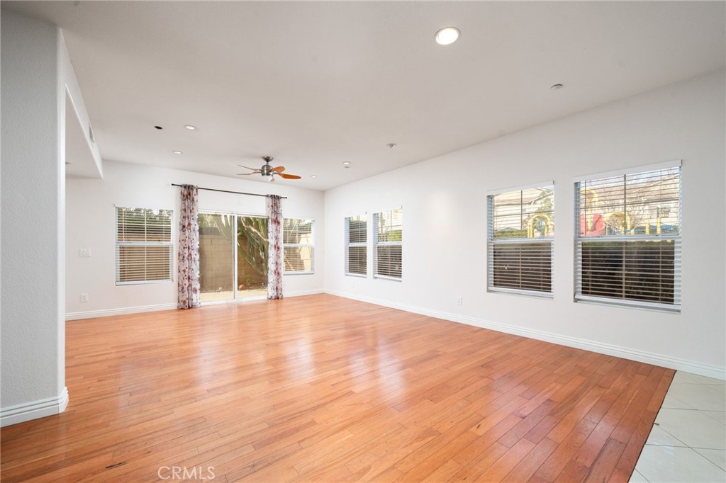 7331 Shelby Place, Unit 102 Rancho Cucamonga, CA 91739 - Photo 7 of 44 a view of an empty room with wooden floor and a window