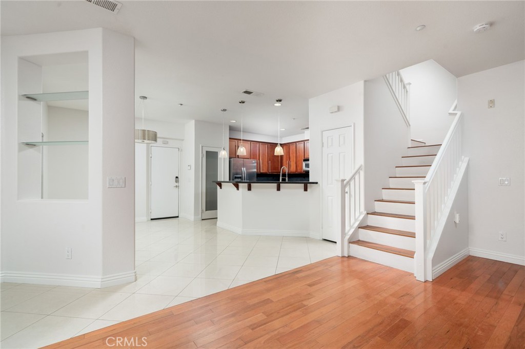7331 Shelby Place, Unit 102 Rancho Cucamonga, CA 91739 - Photo 9 of 44 a view of a room with stairs and wooden floor