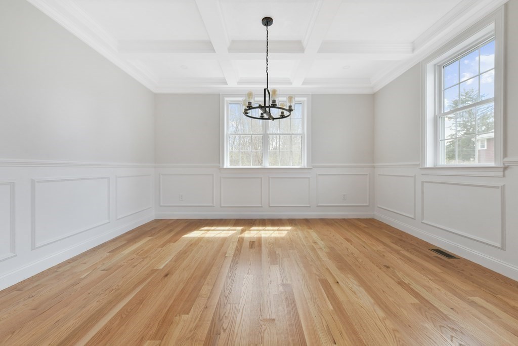 35 Roosevelt Road Dedham, MA 02026 - Photo 13 of 40 a view of empty room with wooden floor and windows