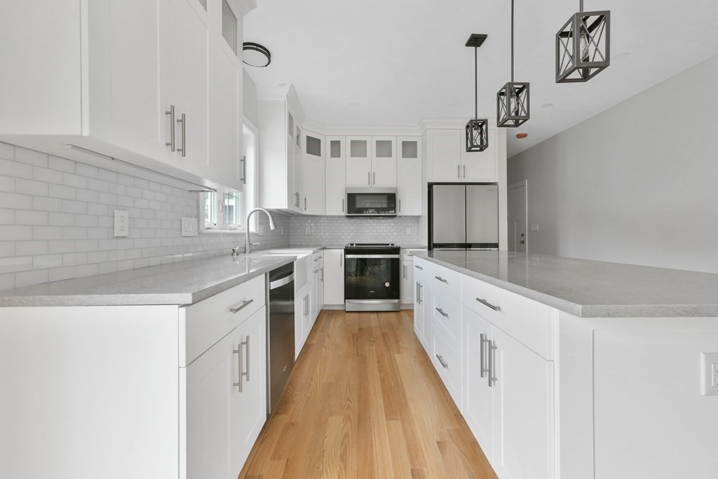 35 Roosevelt Road Dedham, MA 02026 - Photo 17 of 40 a kitchen with cabinets a sink and appliances
