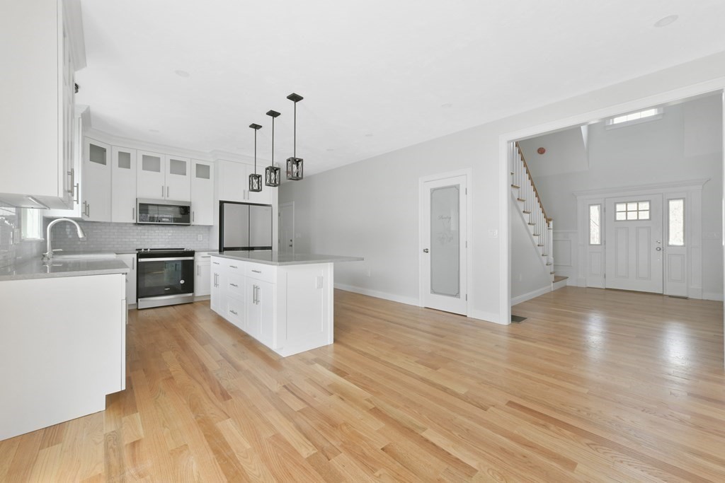 35 Roosevelt Road Dedham, MA 02026 - Photo 20 of 40 a view of a kitchen with wooden floor and electronic appliances