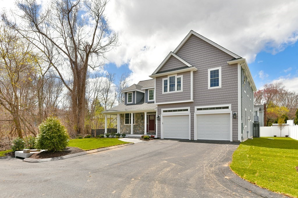 35 Roosevelt Road Dedham, MA 02026 - Photo 2 of 40 a front view of a house with a yard and garage
