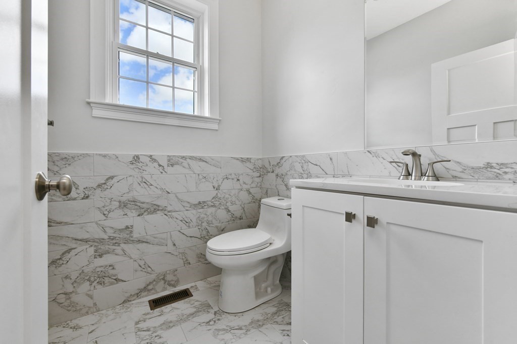 35 Roosevelt Road Dedham, MA 02026 - Photo 24 of 40 a bathroom with a sink toilet and a mirror