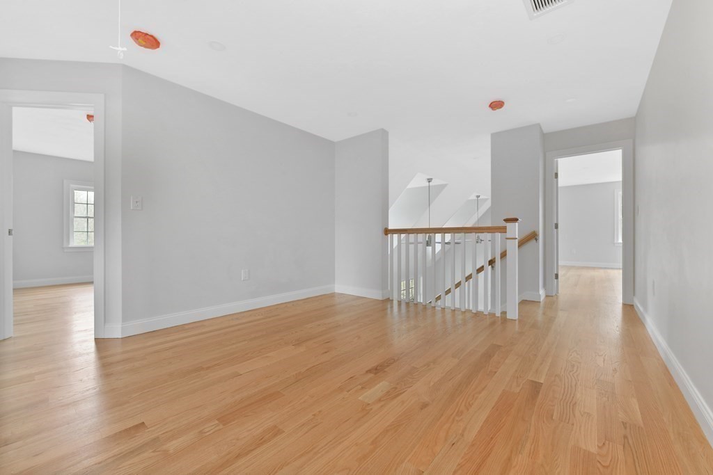 35 Roosevelt Road Dedham, MA 02026 - Photo 26 of 40 a view of a hallway with wooden floor and entryway