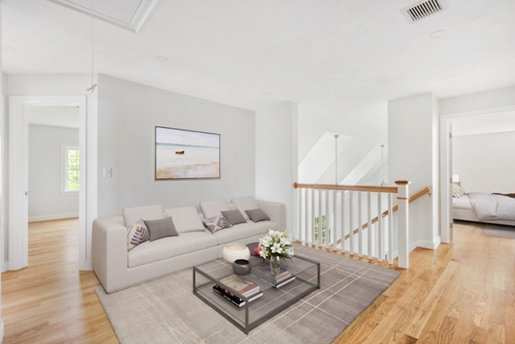35 Roosevelt Road Dedham, MA 02026 - Photo 27 of 40 a living room with furniture and a table with wooden floor
