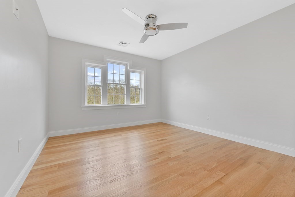 35 Roosevelt Road Dedham, MA 02026 - Photo 32 of 40 an empty room with windows and ceiling fan