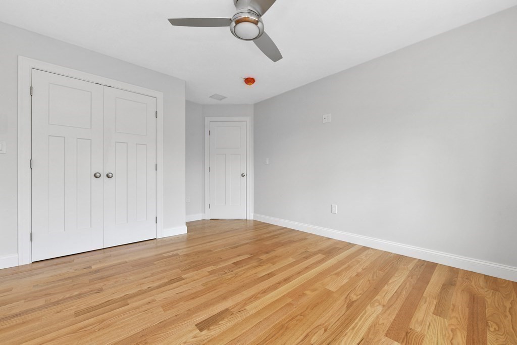 35 Roosevelt Road Dedham, MA 02026 - Photo 33 of 40 a view of empty room with wooden floor and ceiling fan