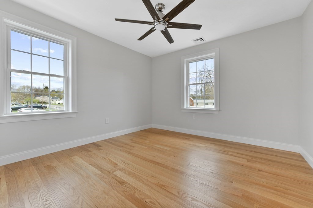 35 Roosevelt Road Dedham, MA 02026 - Photo 34 of 40 a view of an empty room with a window and wooden floor