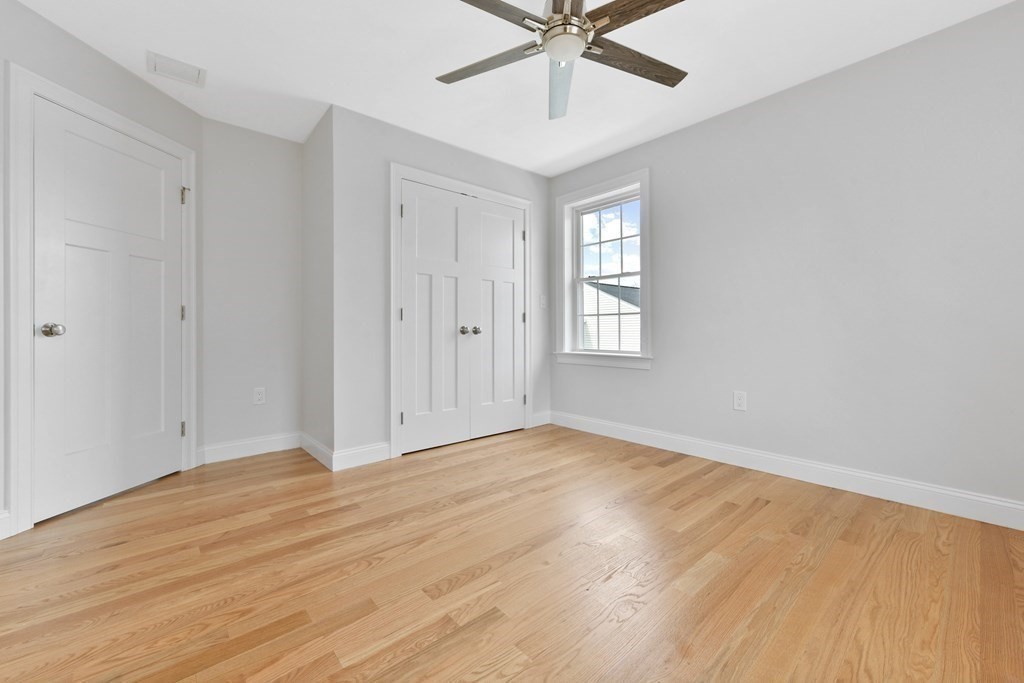 35 Roosevelt Road Dedham, MA 02026 - Photo 35 of 40 a view of an empty room with wooden floor and a window