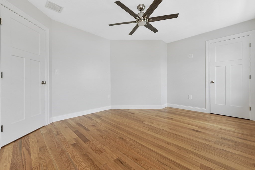 35 Roosevelt Road Dedham, MA 02026 - Photo 37 of 40 a view of a room with wooden floor and a ceiling fan