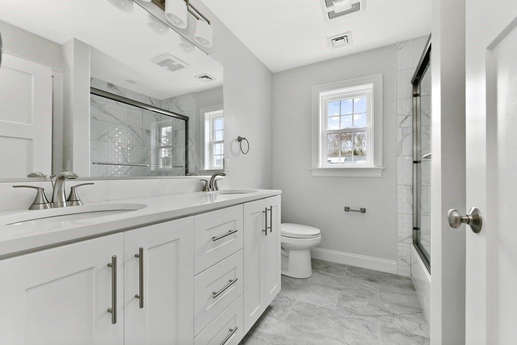 35 Roosevelt Road Dedham, MA 02026 - Photo 38 of 40 a bathroom with a granite countertop sink toilet and shower