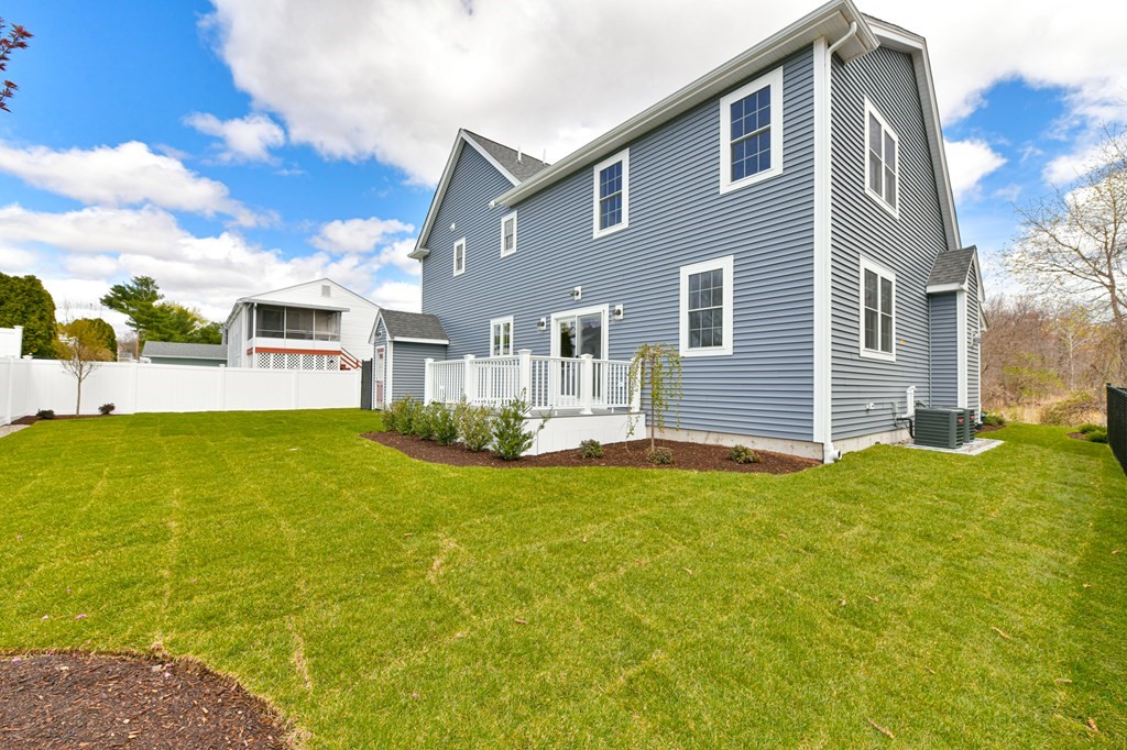 35 Roosevelt Road Dedham, MA 02026 - Photo 4 of 40 a front view of a house with a yard