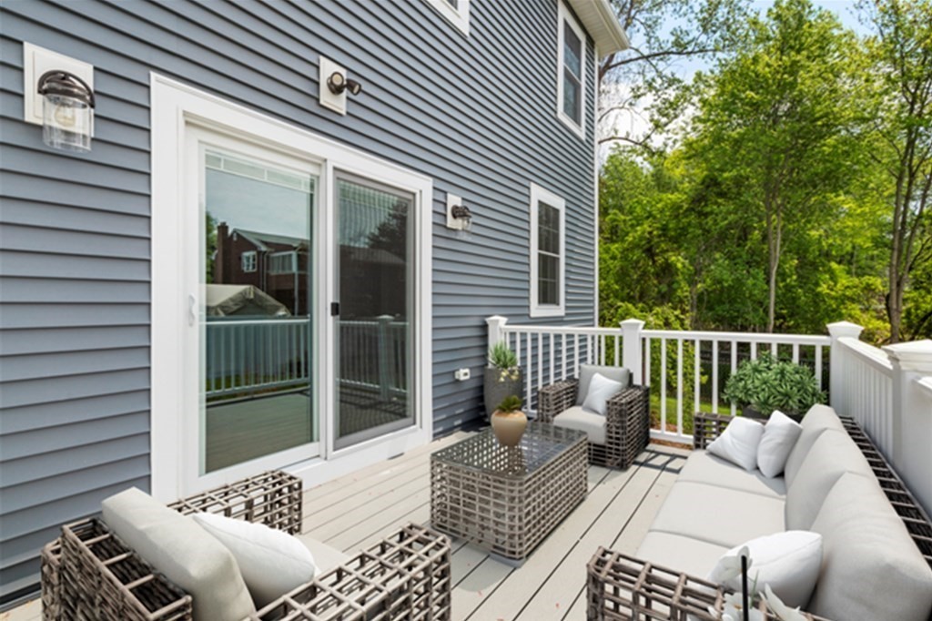 35 Roosevelt Road Dedham, MA 02026 - Photo 7 of 40 a balcony view with a couch and wooden floor