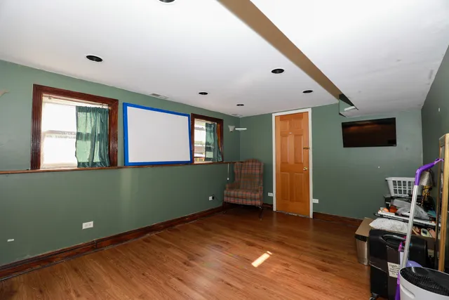 a view of room with wooden floor and windows
