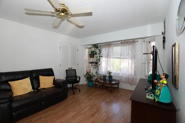 a living room with furniture gym equipment and a window