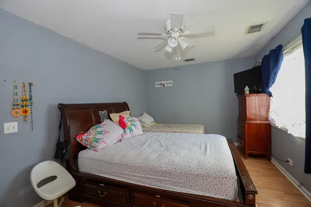 a bedroom with a bed and a chandelier