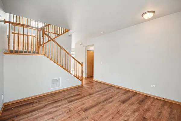 a view of an entryway with wooden floor