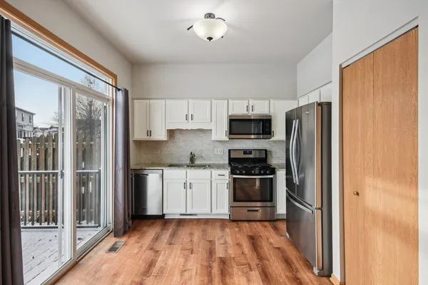 a kitchen with stainless steel appliances a refrigerator and a stove top oven