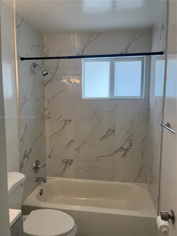 a bathroom with a toilet and a bathtub