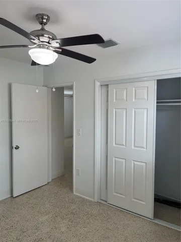 a view of a chandelier fan and closet area