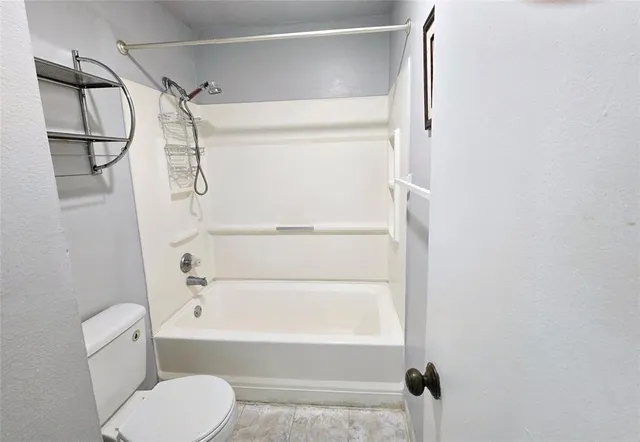 an empty room with a ceiling fan and window