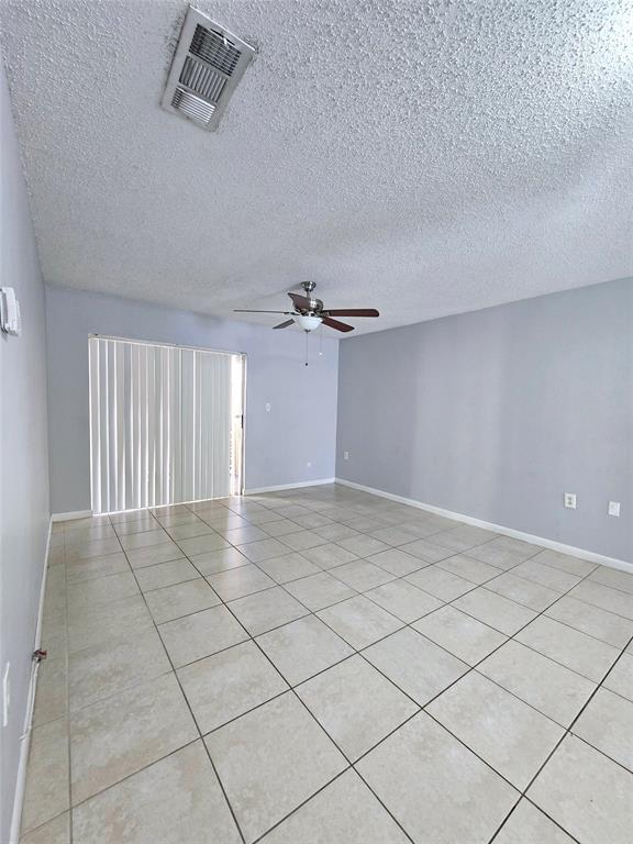 8100 Southwest 21st Court, Unit 8100 Miramar, FL 33025 - Photo 22 of 22 an empty room with a ceiling fan and window