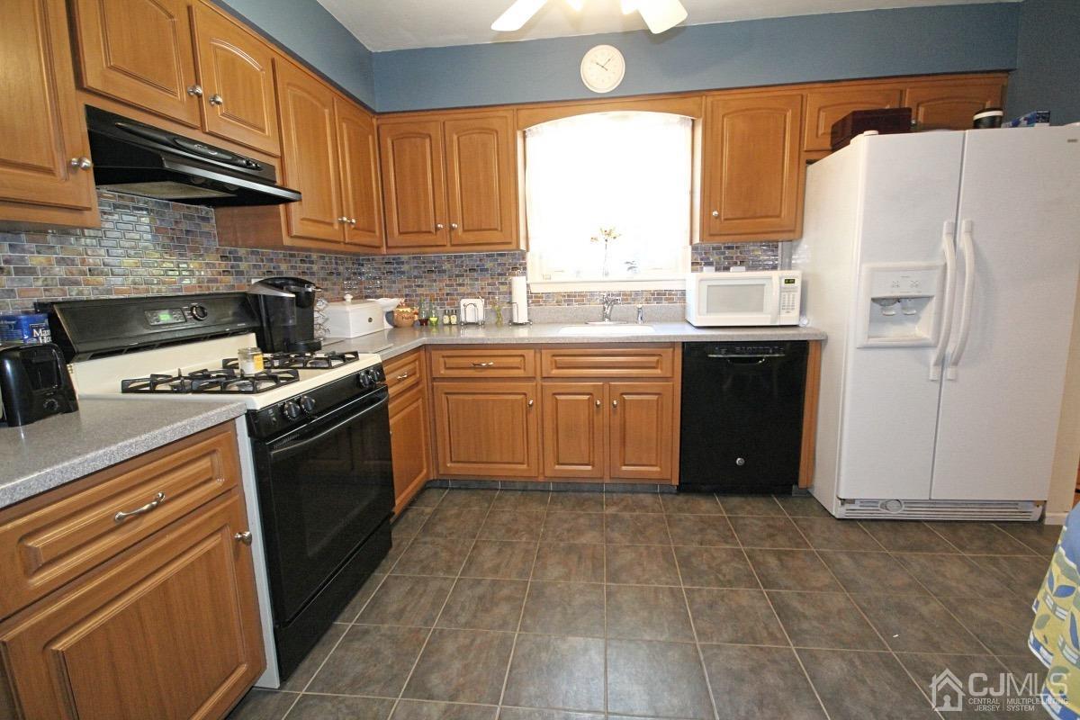 17 Higgins Road Old Bridge, NJ 08857 - Photo 11 of 30 a kitchen with granite countertop a refrigerator sink and cabinets