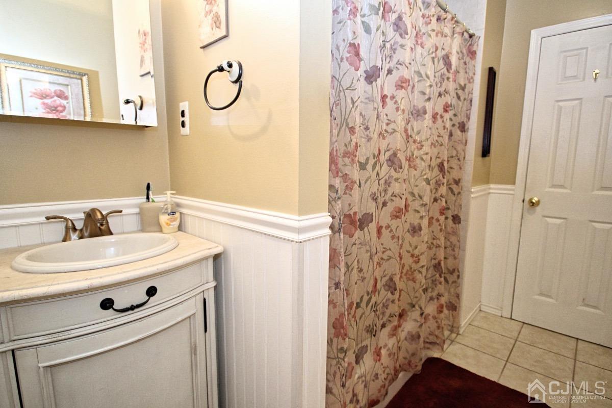 17 Higgins Road Old Bridge, NJ 08857 - Photo 14 of 30 a bathroom with a sink a vanity and a mirror