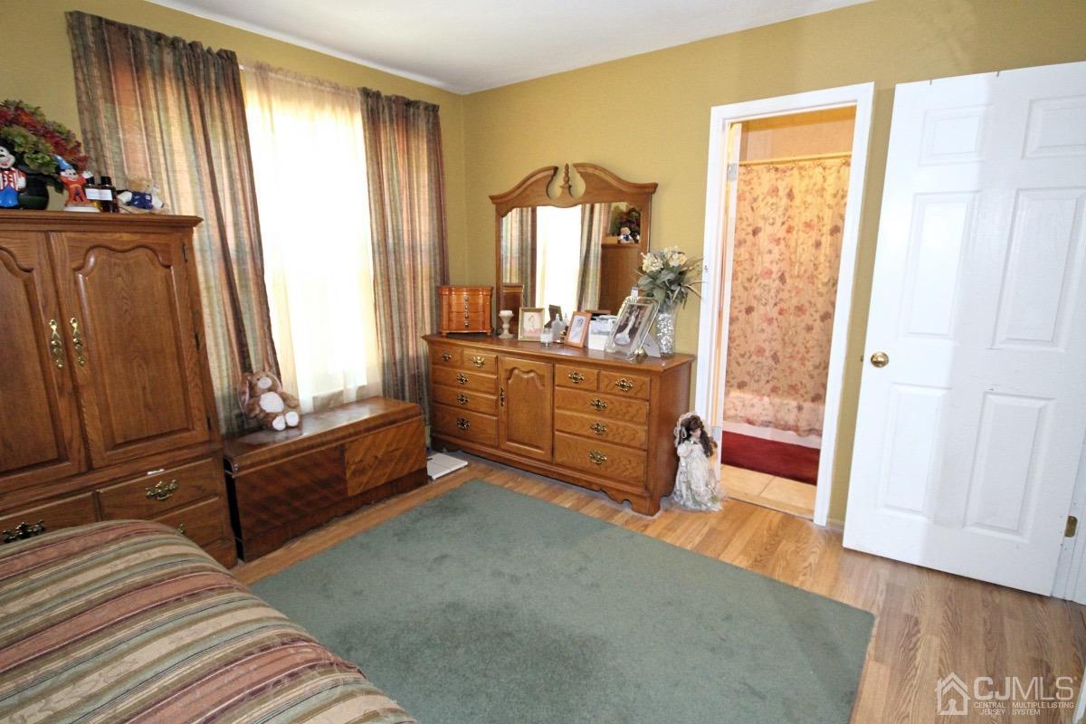 17 Higgins Road Old Bridge, NJ 08857 - Photo 16 of 30 a view of a bedroom with wooden floor and furniture