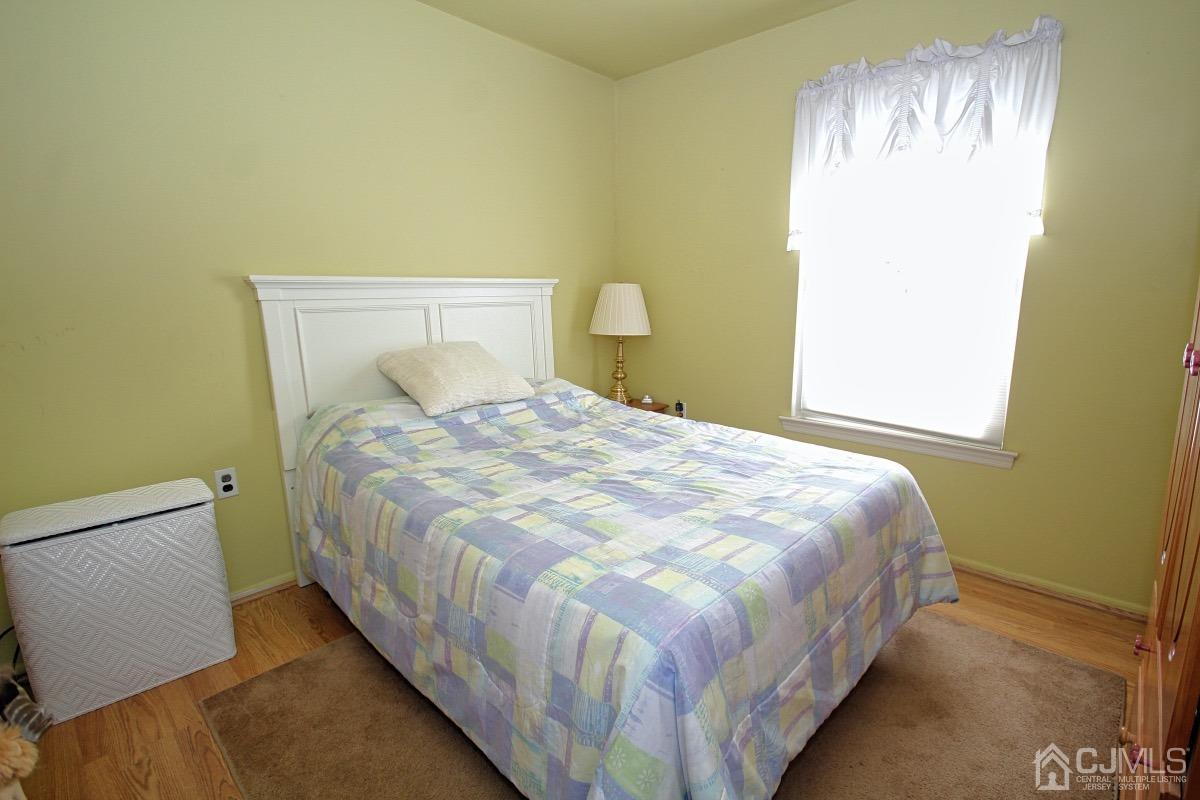 17 Higgins Road Old Bridge, NJ 08857 - Photo 18 of 30 a large bed sitting in a bedroom next to a window